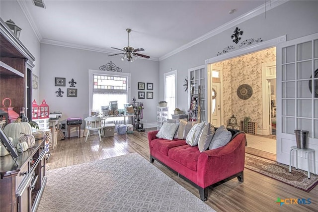 living room featuring hardwood / wood-style flooring, crown molding, and ceiling fan