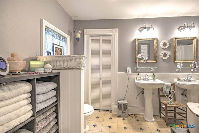 bathroom with tile patterned floors and toilet