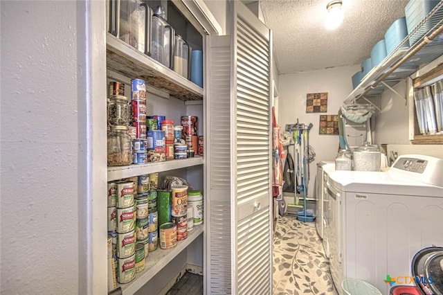 laundry area featuring separate washer and dryer and a textured ceiling