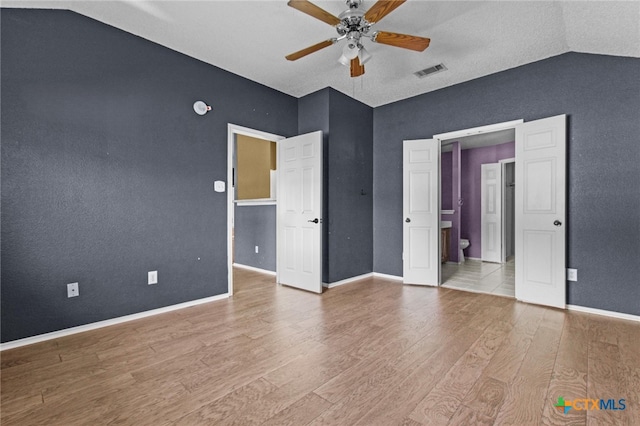 5105 Parkwood Dr, Killeen, TX 76542 - empty room featuring ceiling fan, vaulted ceiling, visible vents, wood finished floors, and baseboards
