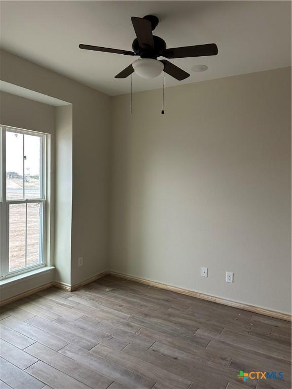 empty room with light hardwood / wood-style flooring