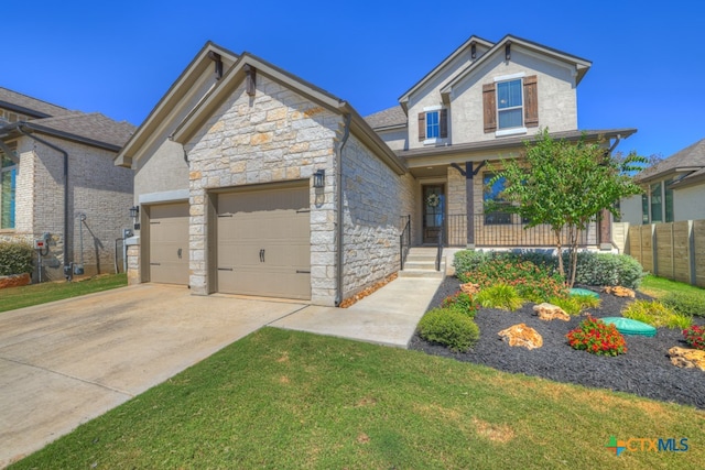 view of front facade with covered porch, stone siding, an attached garage, and driveway