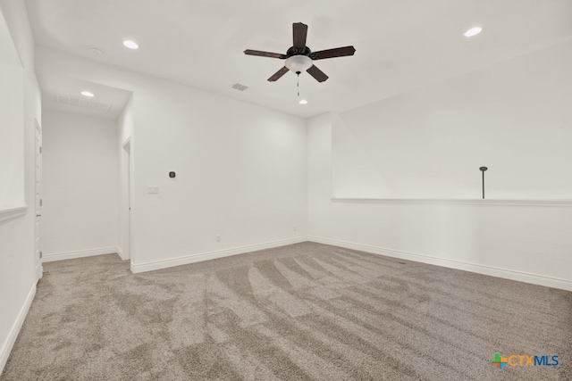 carpeted spare room with ceiling fan