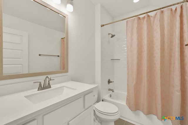 full bathroom with shower / tub combo with curtain, vanity, toilet, and tile patterned flooring