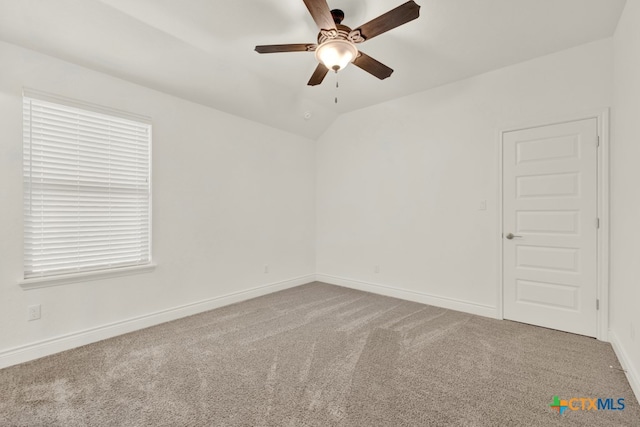 spare room with carpet floors, ceiling fan, and lofted ceiling