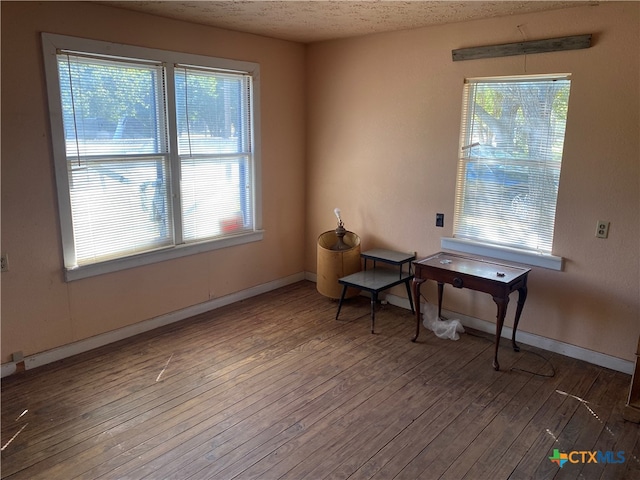 miscellaneous room with a textured ceiling and hardwood / wood-style flooring