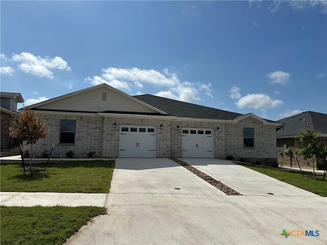5106 Rose Petal Ct, Killeen, TX 76542 - ranch-style house featuring a garage, concrete driveway, brick siding, and a front lawn