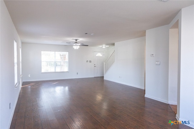 empty room with dark wood-type flooring and ceiling fan