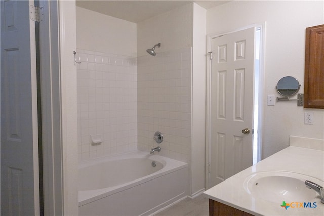 bathroom featuring vanity and tiled shower / bath combo