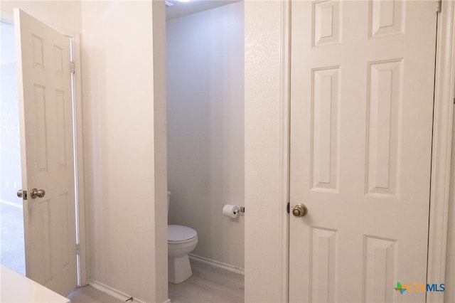 bathroom featuring hardwood / wood-style floors and toilet