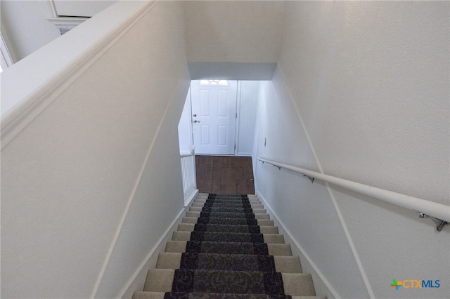 stairs featuring hardwood / wood-style flooring