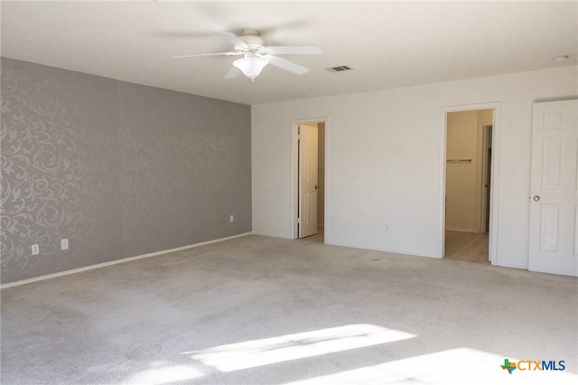 spare room with light carpet and ceiling fan