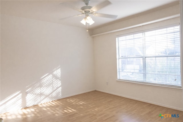 spare room with hardwood / wood-style flooring and ceiling fan