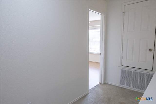 hallway with light carpet