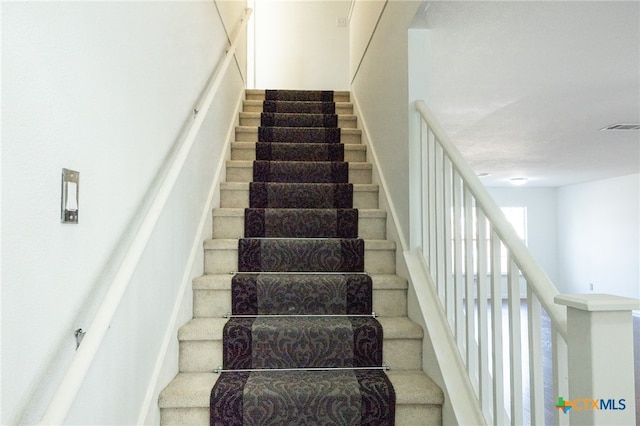 staircase featuring a wealth of natural light