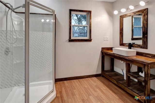 bathroom featuring sink, hardwood / wood-style flooring, and walk in shower