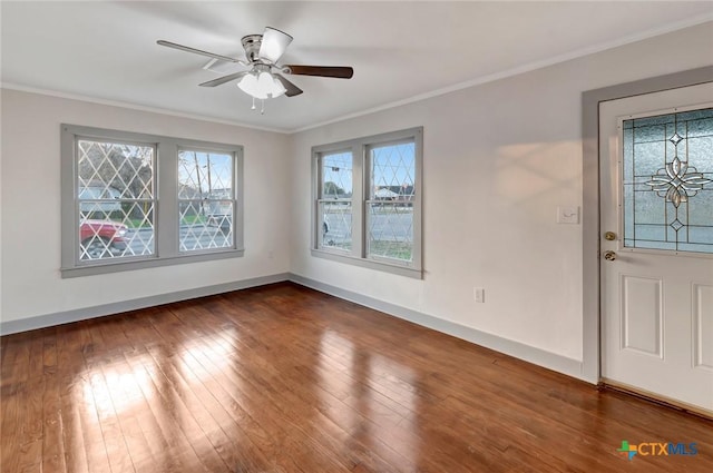 entrance foyer featuring dark hardwood / wood-style flooring, ornamental molding, and ceiling fan