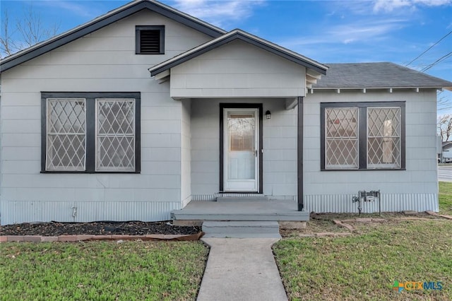 bungalow featuring a front lawn