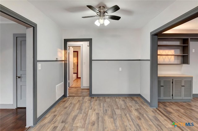 unfurnished dining area with hardwood / wood-style flooring and ceiling fan