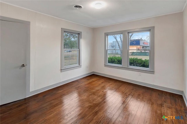 unfurnished room with crown molding and dark hardwood / wood-style floors