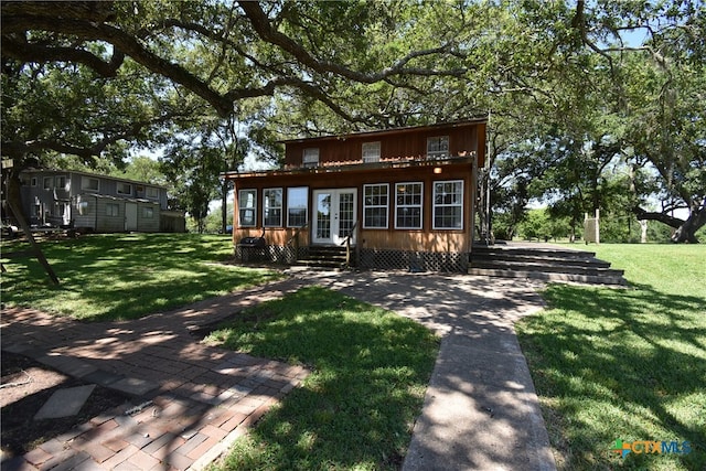 rear view of house with a yard