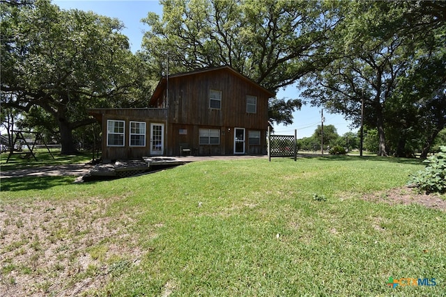 back of house with a lawn