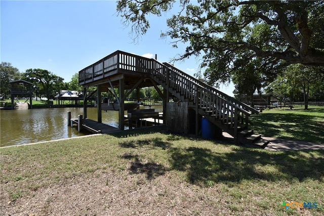 view of dock with a water view and a lawn