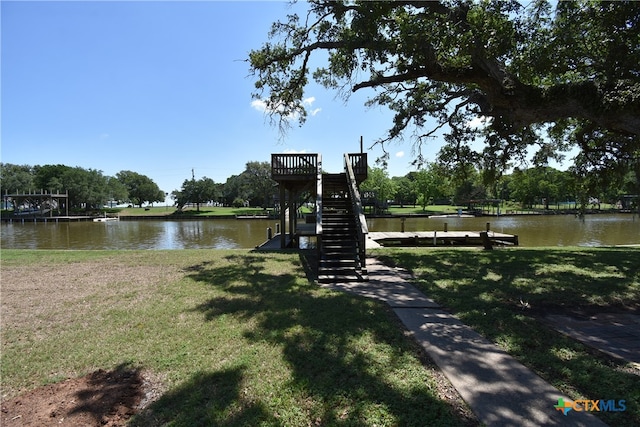 dock area featuring a water view and a lawn