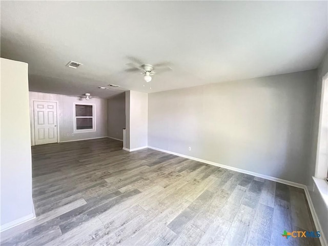 348 N Burke St, Goliad, TX 77963 - unfurnished room featuring baseboards, ceiling fan, and wood finished floors