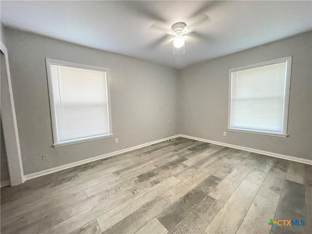 348 N Burke St, Goliad, TX 77963 - empty room with ceiling fan, wood finished floors, and a wealth of natural light