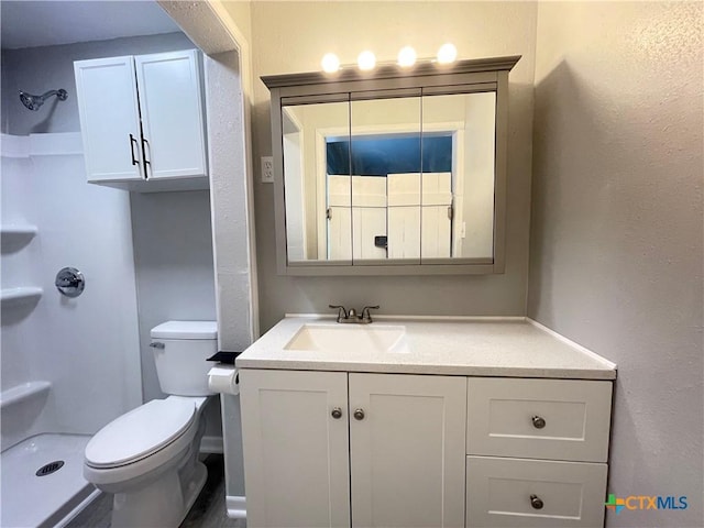 348 N Burke St, Goliad, TX 77963 - bathroom featuring vanity, walk in shower, and toilet