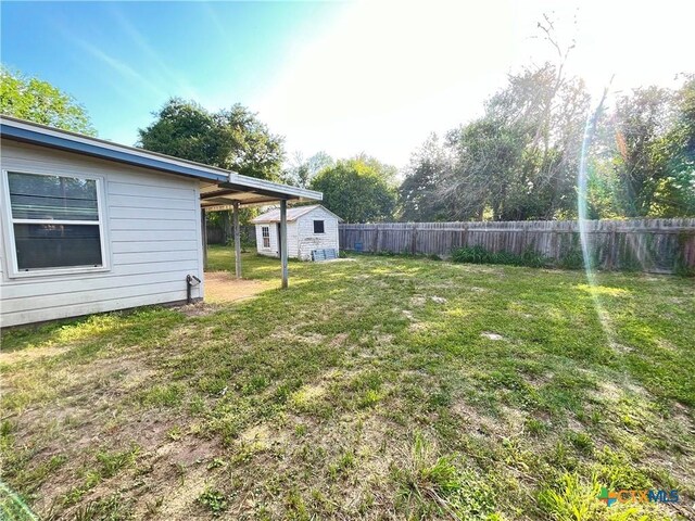 348 N Burke St, Goliad, TX 77963 - view of yard featuring a fenced backyard, an outbuilding, and a shed