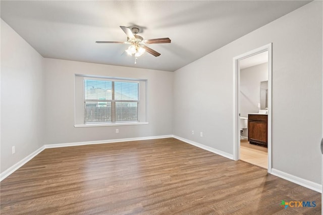 unfurnished bedroom with baseboards, wood finished floors, and a ceiling fan