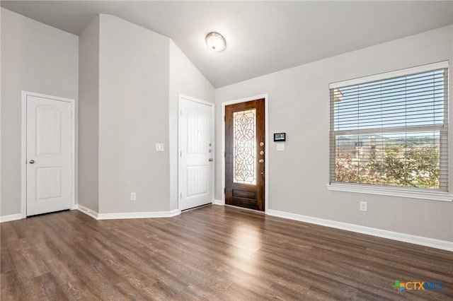 entryway with baseboards, wood finished floors, and vaulted ceiling