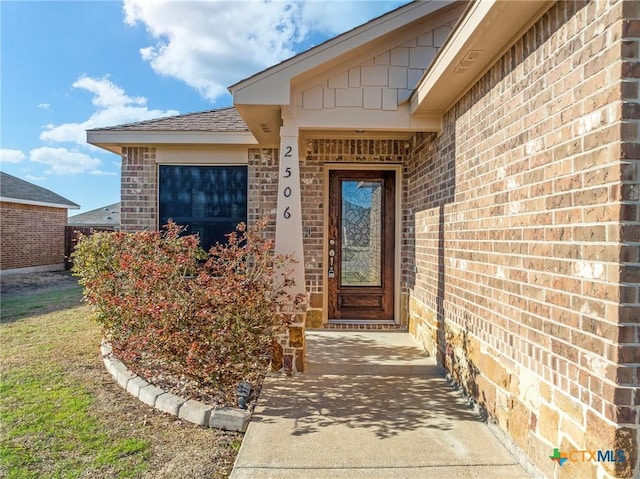 doorway to property with brick siding