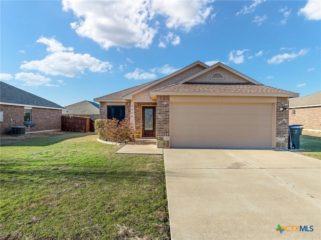 ranch-style house featuring roof with shingles, a front lawn, concrete driveway, a garage, and brick siding