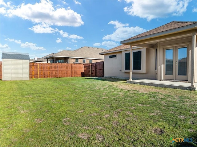 view of yard with an outbuilding, a patio area, a storage shed, and fence