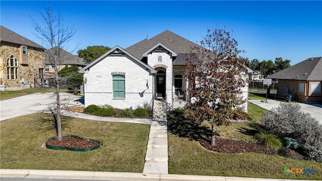 french country style house with a front yard