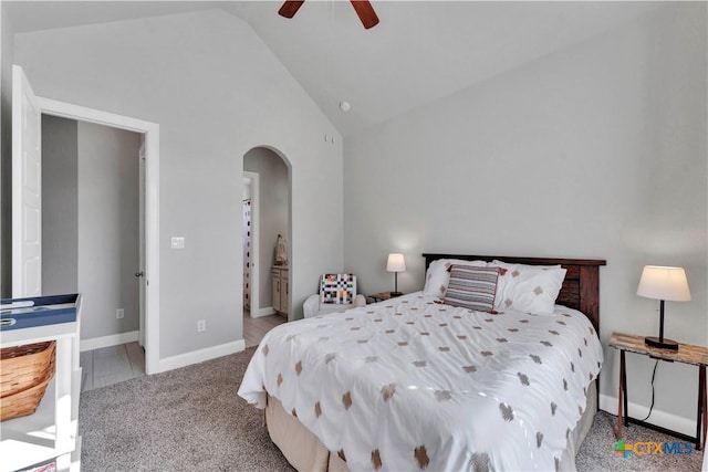 bedroom with ceiling fan, light colored carpet, and high vaulted ceiling