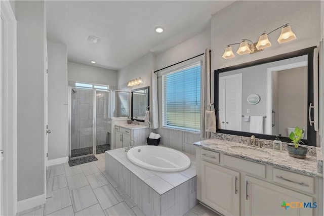 bathroom featuring vanity, tile patterned floors, plenty of natural light, and independent shower and bath