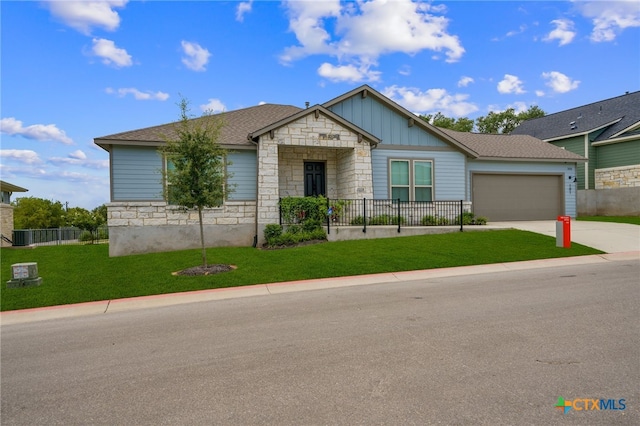 view of front of property featuring a front lawn and a garage