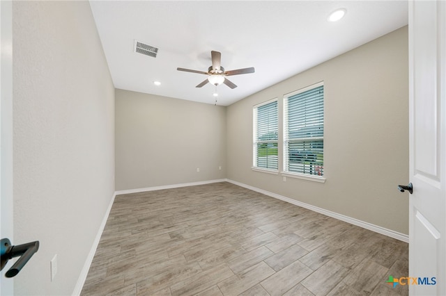 spare room with ceiling fan and light hardwood / wood-style flooring