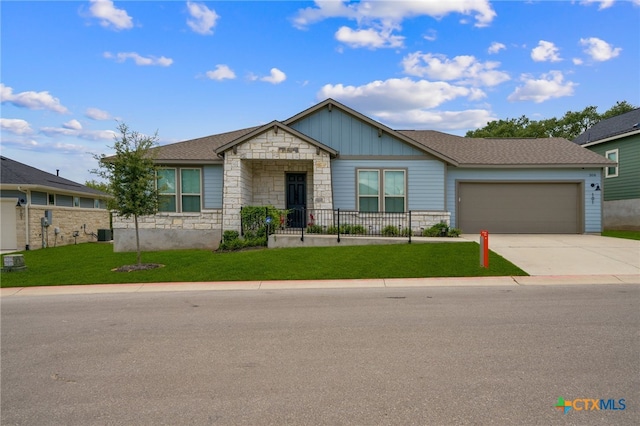 view of front of house with a garage and a front yard