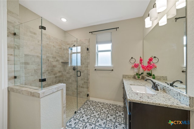 bathroom with walk in shower, vanity, and tile patterned flooring