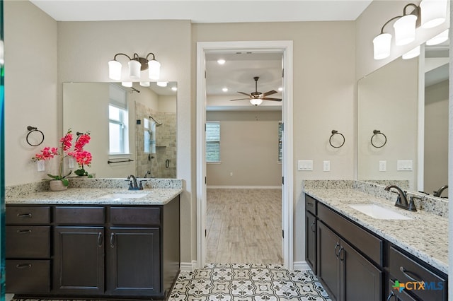 bathroom with hardwood / wood-style floors, vanity, ceiling fan, and a shower with shower door