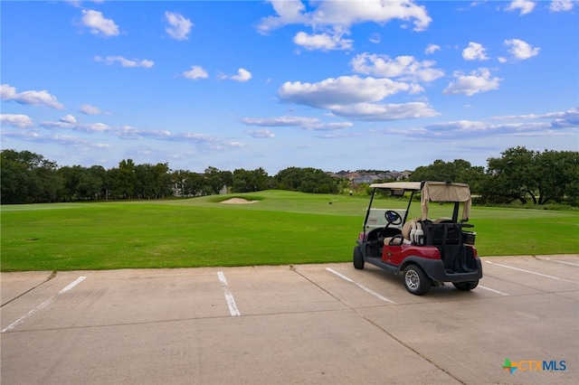 view of vehicle parking with a lawn