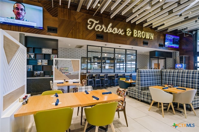 interior space with a high ceiling and tile patterned floors