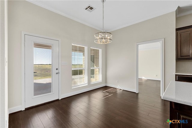 85 Grellhesl Rd, West, TX 76691 - unfurnished dining area featuring crown molding, a chandelier, dark wood-style floors, and baseboards