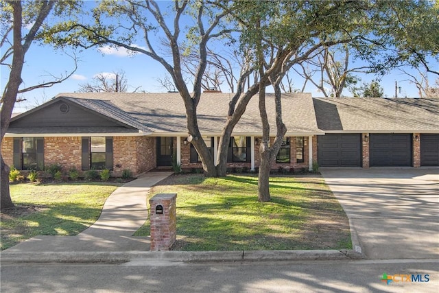 single story home featuring a garage and a front lawn