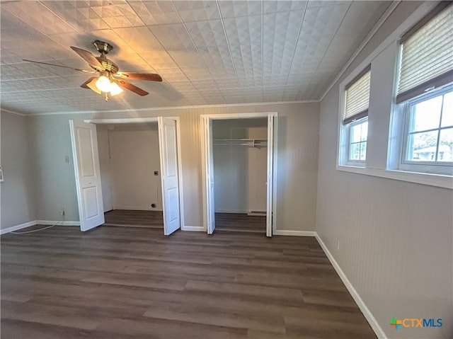 unfurnished bedroom with ceiling fan, dark hardwood / wood-style floors, and crown molding